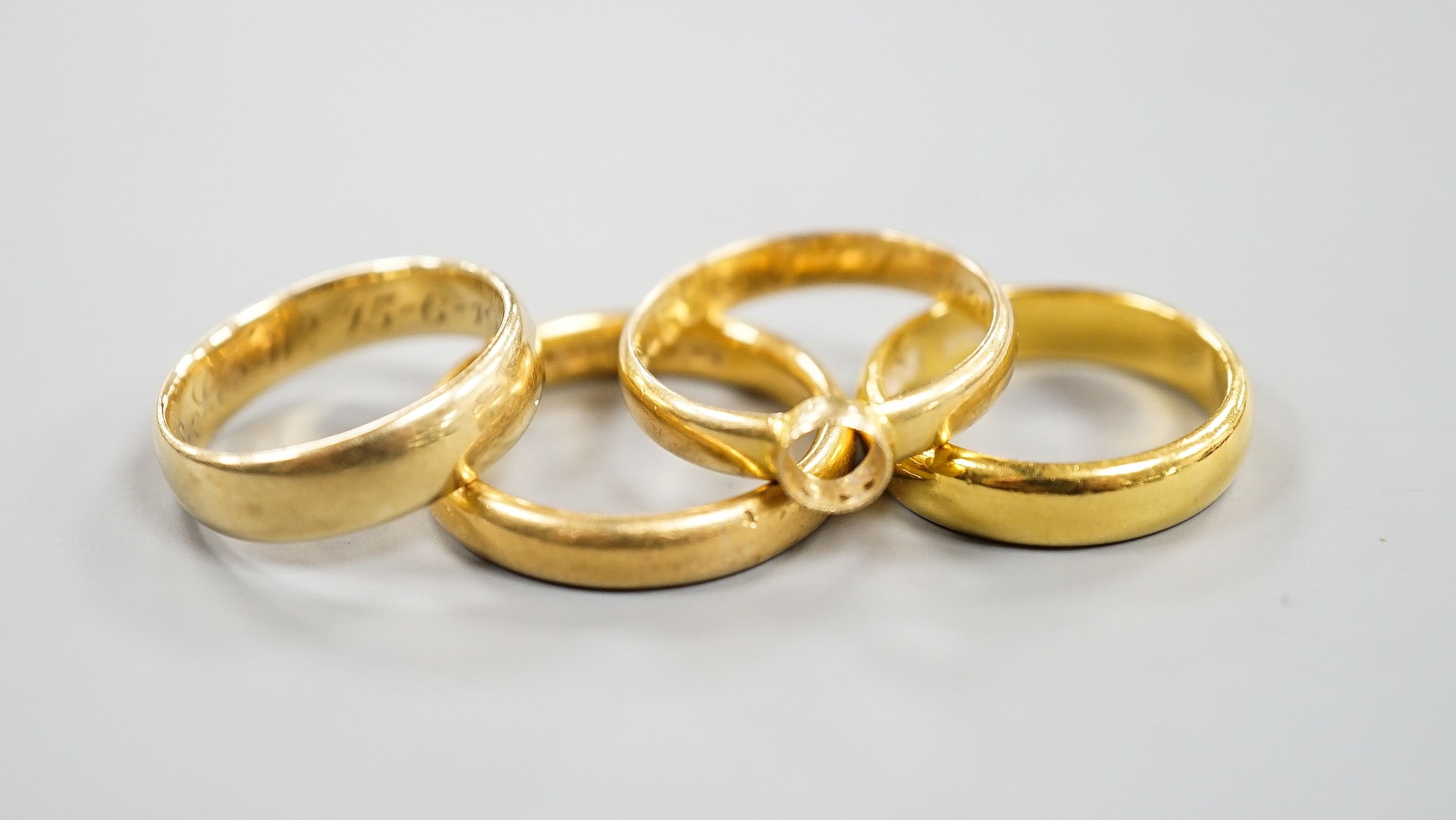 Two 22ct gold wedding bands, 10.3 grams, a George V 18ct gold wedding band and a Victorian 18ct gold shank, 6.6 grams.